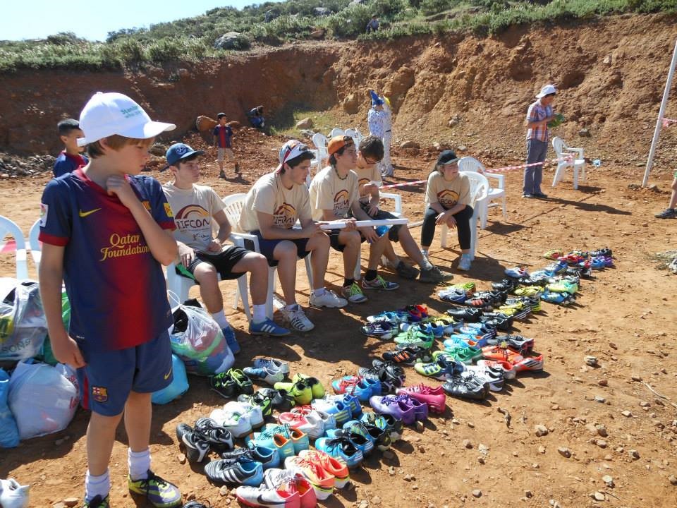 Students from Swans International School, Marbella, handing out donated football boots to the players
